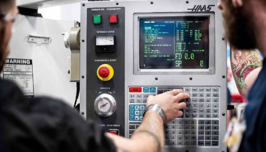 The CNC operators enters data on the machine control panel. Lease a CNC machine operator for precision machining.