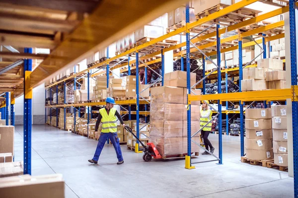 Warehouse workers perform loading and unloading operations and move goods in the warehouse to organise efficiently